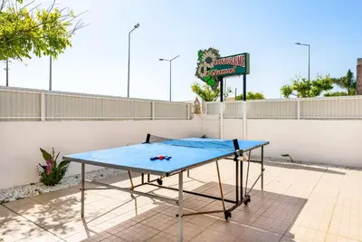 a ping pong table in front of a fence at Villa Girassol in Galé