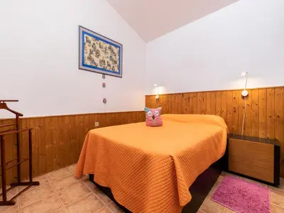 a room with a table with a orange blanket on it at Akivillas Loulé Holiday in Espargal