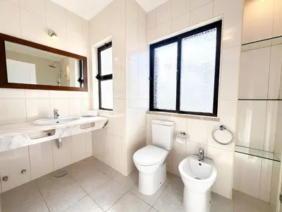 a bathroom with a toilet and a sink and a mirror at Villa Brasil by BeCherish in Quarteira