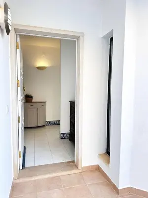 a hallway with a door leading into a room at Villa Brasil by BeCherish in Quarteira