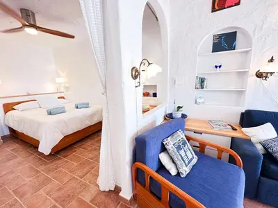a bedroom with a bed and a blue chair at Charming AlgarvianOceanfront Townhouse by BeCherish in Albufeira