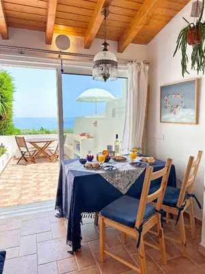 a dining room with a table and a view of the ocean at Charming AlgarvianOceanfront Townhouse by BeCherish in Albufeira