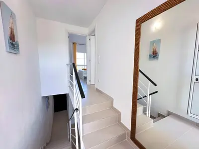 a staircase in a house with a mirror at Windmill Hill Cozy Townhouse by BeCherish in Albufeira
