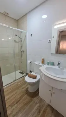 a bathroom with a toilet and a sink and a shower at Sunbeam Home - Albufeira in Albufeira