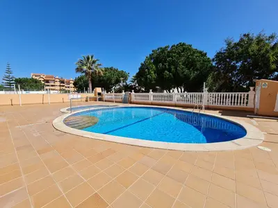 a swimming pool in a patio with a fence and trees at Sunbeam Home - Albufeira in Albufeira