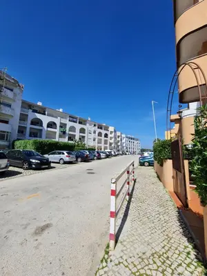 a street with cars parked on the side of a building at Sunbeam Home - Albufeira in Albufeira