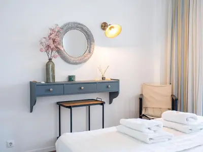 a bedroom with a blue dresser and a bed with towels at Balaia Praia Apartment by Stay ici Algarve Holiday Rental in Albufeira
