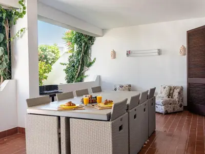 a dining room with a table and chairs at Balaia Praia Apartment by Stay ici Algarve Holiday Rental in Albufeira