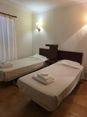 two beds in a hotel room with towels on them at V3 Villa in Albufeira in Albufeira