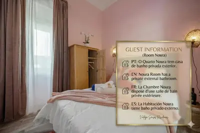 a bedroom with a bed with white sheets and pillows at Vintage Senses Residences in Faro