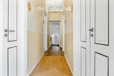 a hallway with white doors and wood floors at Vintage Senses Residences in Faro