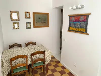 a dining room with a table and chairs at Moradia Mini Apartment in Faro