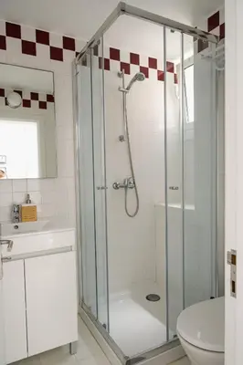 a bathroom with a shower with a toilet and a sink at Moradia Mini Apartment in Faro
