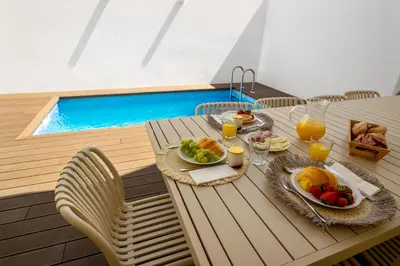 an office with a desk and a chair in a room at Mae Joana pool&beach Faro villa in Faro