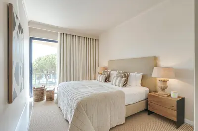 a hotel room with a bed and a window at Apartamento T2 renovado no Vila Sol com piscina in Vilamoura