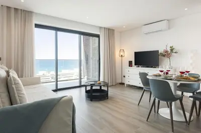 a living room with a table and a dining room at Terracos de Quarteira II Cherry by Real Properties in Quarteira