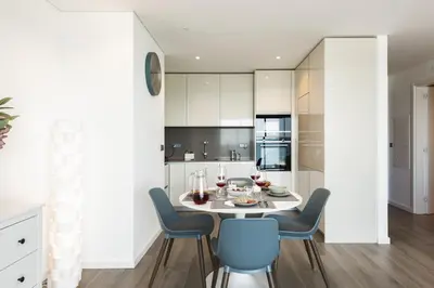 a dining room with a table and chairs at Terracos de Quarteira II Cherry by Real Properties in Quarteira