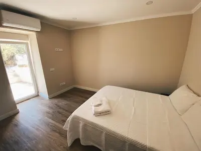 a bedroom with a white bed and a window at Country villa in Algarve, 15 min from beach in Albufeira