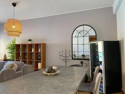 a dining room with a table and a living room at Marina Pool & Sea in Albufeira