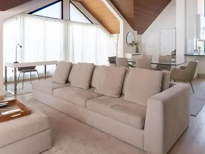 a living room with a couch and a table at Premium Apartment with Vilamoura Marina View in Vilamoura