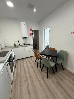 a kitchen and dining room with a table and chairs at Camilas place in Faro