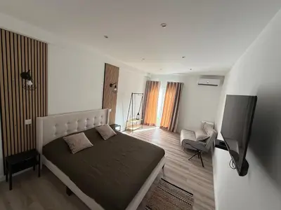 a bedroom with a bed and a flat screen tv at Camilas place in Faro