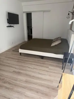 a bedroom with a bed and a flat screen tv at Camilas place in Faro