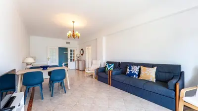 a living room with a blue couch and a table at Cozy 1Bdr Flat w Pool in Vilamoura by Lovelystay in Quarteira