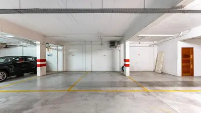 a parking garage with a car parked in it at Cozy 1Bdr Flat w Pool in Vilamoura by Lovelystay in Quarteira
