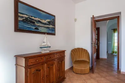 a living room with a brick fireplace with a tv at Blife Moustachya Villa in Faro