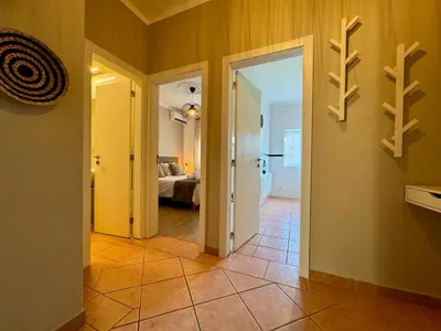 a hallway with a door leading to a bedroom at Cosy 1-Bedroom Apartment with Private Terrace in Loulé in Loulé