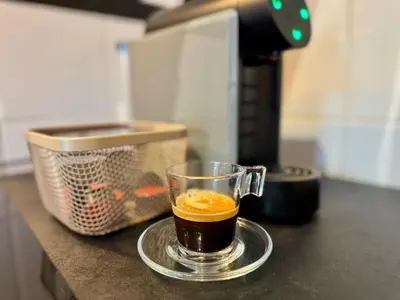 a cup of coffee on a plate on a counter at Cosy 1-Bedroom Apartment with Private Terrace in Loulé in Loulé