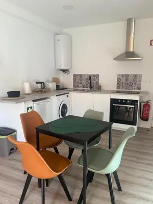 a kitchen with a table and chairs in a kitchen at Camilas Place 2 in Bicas