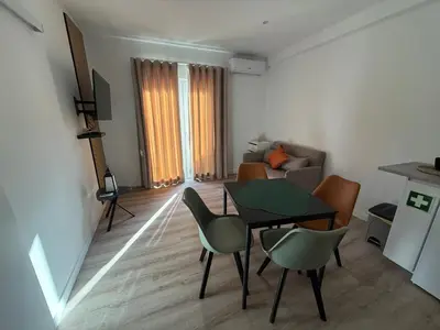 a living room with a table and chairs and a couch at Camilas Place 2 in Bicas