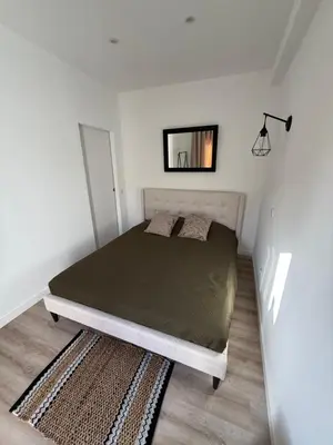 a bedroom with a bed with a mirror on the wall at Camilas Place 2 in Bicas