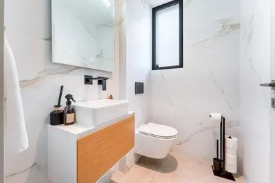 a white bathroom with a sink and a toilet at Villa Memorias by Algarve Holidays in Páteo