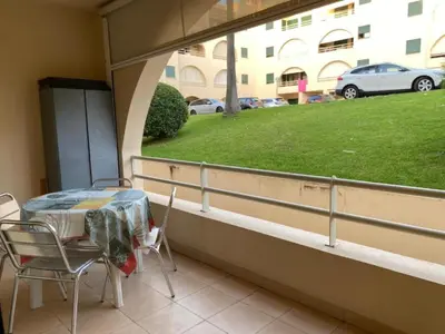 a balcony with a table and chairs and a window at Salgados Village, Santos Apartment in Guia