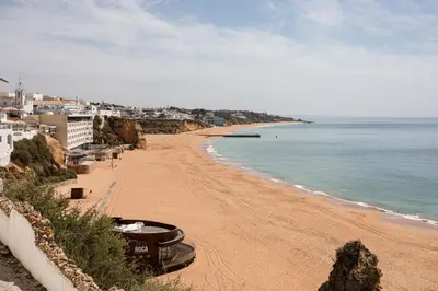a view of a beach with the ocean and buildings at Budget Beach Center B5 in Albufeira