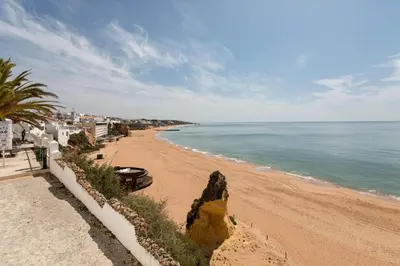 a view of a beach with the ocean and buildings at Budget Beach Center B5 in Albufeira