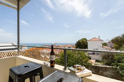 a bottle of wine sitting on a balcony with a sink at Budget Beach Center B5 in Albufeira