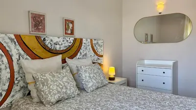 a bedroom with a bed with a mirror on the wall at 150m to the beach at Sol a Sul apartments in Albufeira