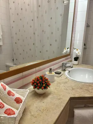 a white bathroom with a toilet and a sink at Aqualux Golden Sun Amazing Holiday in Albufeira