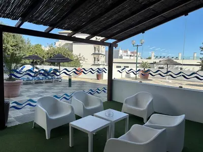 a group of chairs and tables on a patio at Aqualux Golden Sun Amazing Holiday in Albufeira