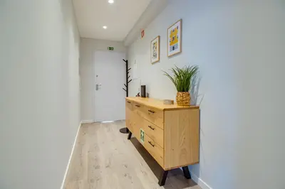 a room with a wooden dresser with a plant on it at Stunning Ocean View Apt Beach 200mt AC Pool in Albufeira