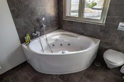 a white bath tub in a bathroom with a toilet at Luxury home in Albufeira in Albufeira
