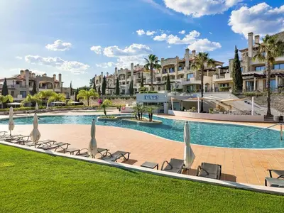 a patio with a table and a chair on a balcony at Apartment Pine Hills Jade by Interhome in Vilamoura