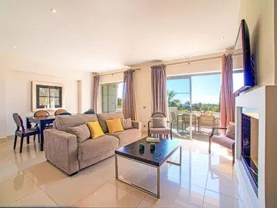 a living room with a couch and a table at Apartment Pine Hills Jade by Interhome in Vilamoura