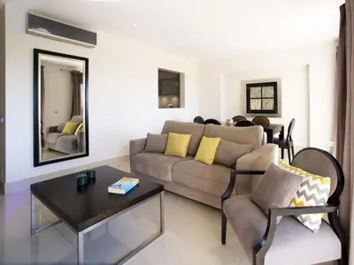a living room with a couch and a table at Apartment Pine Hills Jade by Interhome in Vilamoura