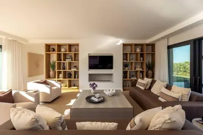 a living room with a couch and a table at Faro Luxury Home with Heated Pool and Garden in Faro