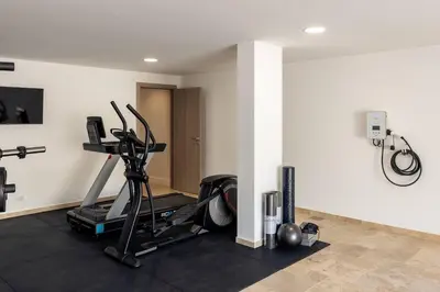 a room with a gym with a treadmill at Faro Luxury Home with Heated Pool and Garden in Faro